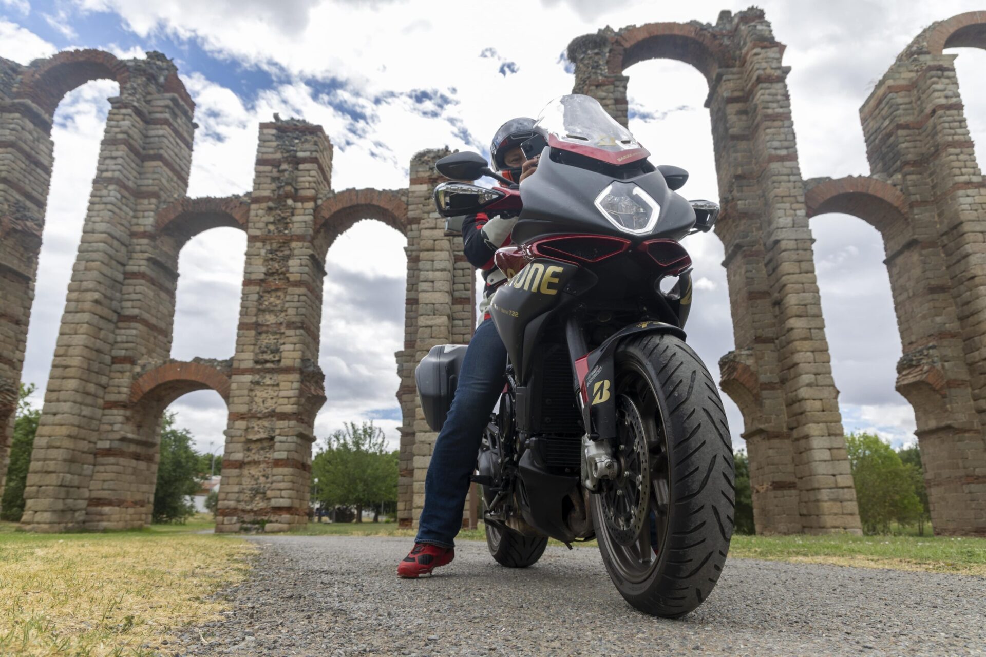 motorcycle rider in front of historic building
