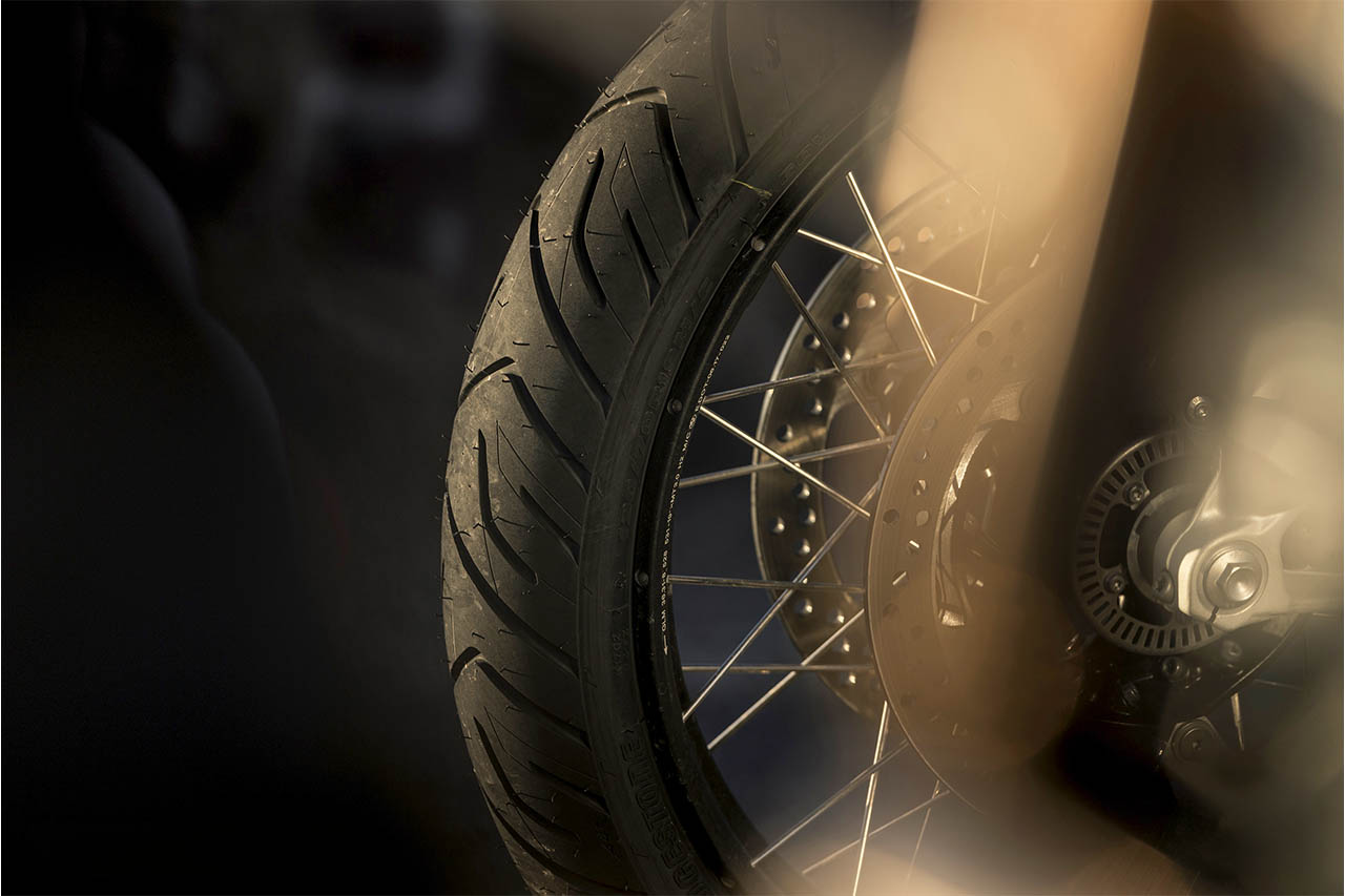 Close-up of a motorcycle wheel fitted with the Bridgestone T33 tyre