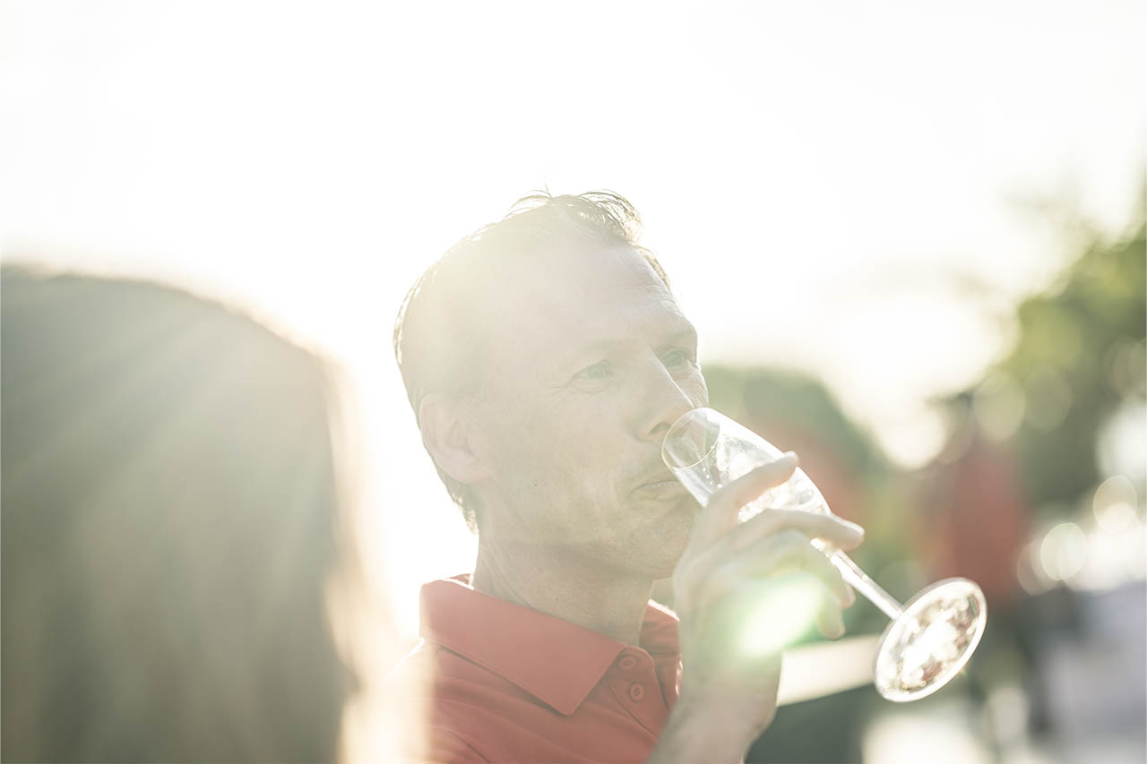 A guest enjoys a drink at the evening reception following the T33 launch event