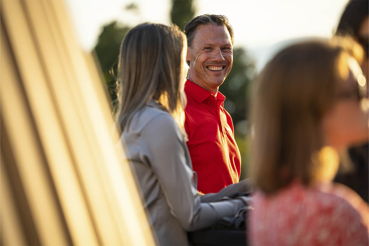Nico Thuy smiling in conversation with attendees at the T33 launch event