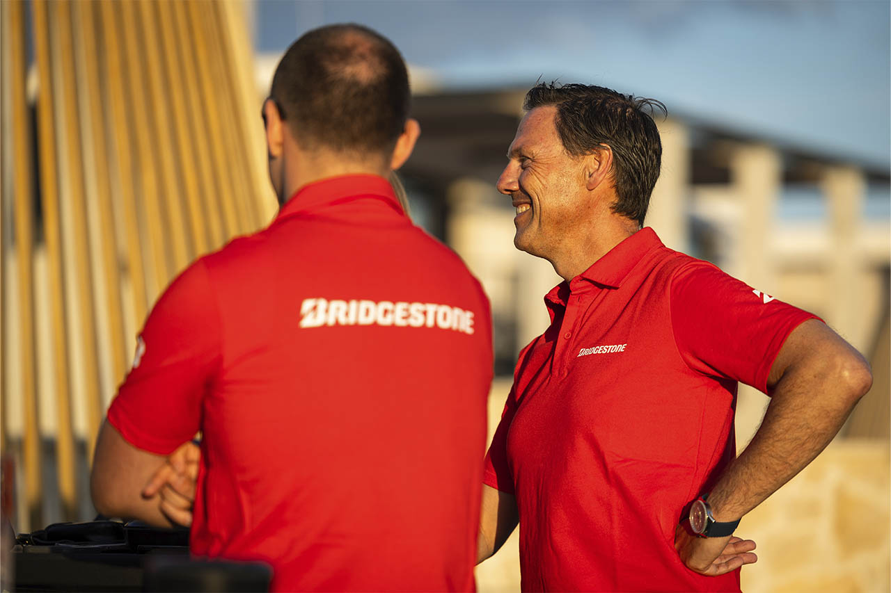 Nico Thuy talking with a Bridgestone colleague outdoors at the T33 launch event in Croatia