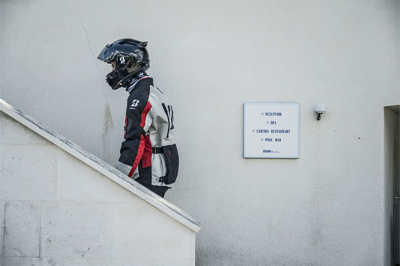 Hubert in riding gear walking down the hotel steps at the Bridgestone T33 launch in Croatia