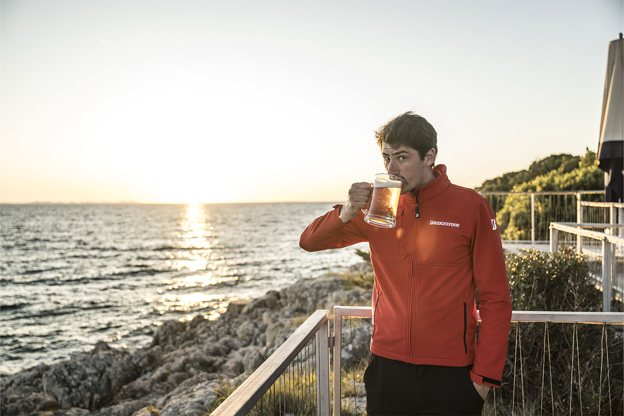 Hubert enjoying a drink on the coast at sunset during the Bridgestone T33 launch