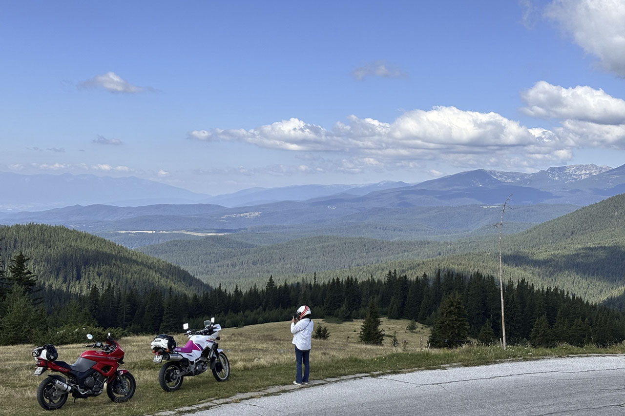 Motorcycles parked at a mountain viewpoint during a Bridgestone AX41S ride in Bulgaria