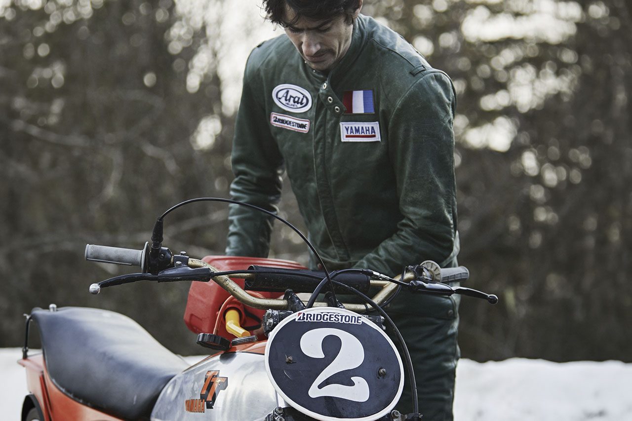 Hubert inspecting a vintage number 2 Yamaha TT racing bike in the snow