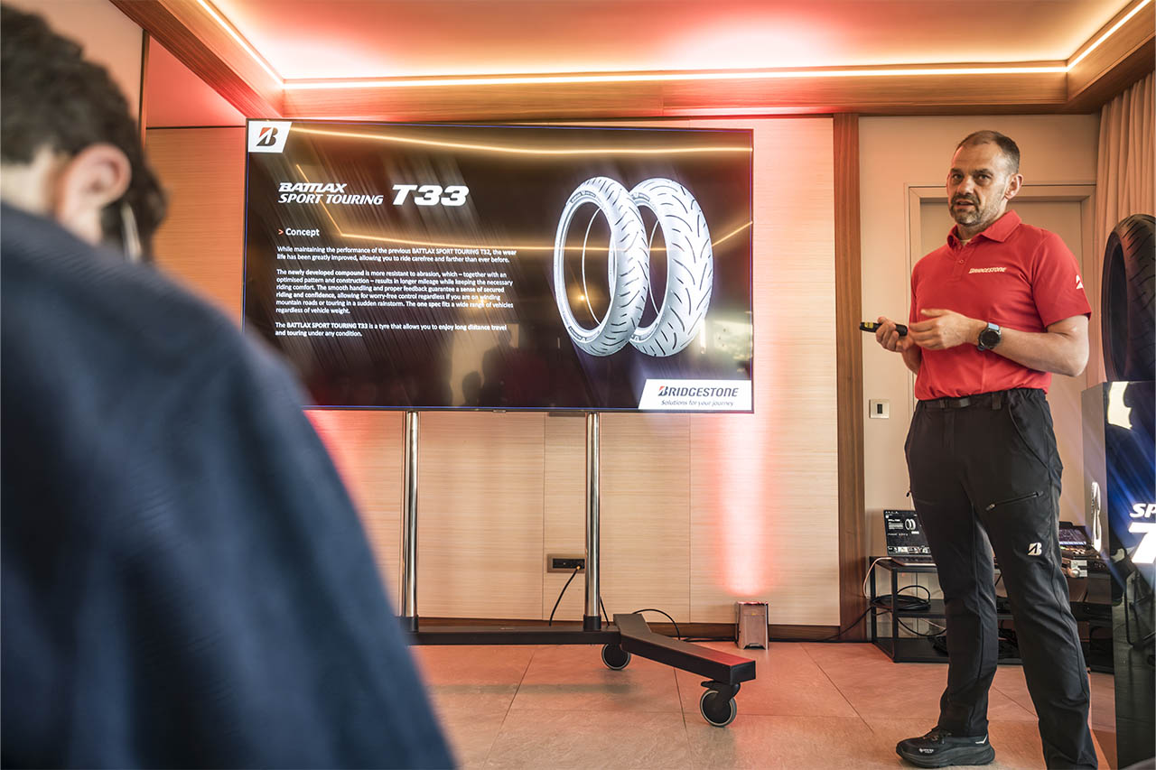Dominique Plom presenting the Battlax Sport Touring T33 concept slide on a large screen.