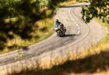 Honda GoldWing in the Vosges on Bridgestone Exedra Tyres Honda GoldWing in gold 50th Anniversary colours leaning into a winding bend through the French countryside.