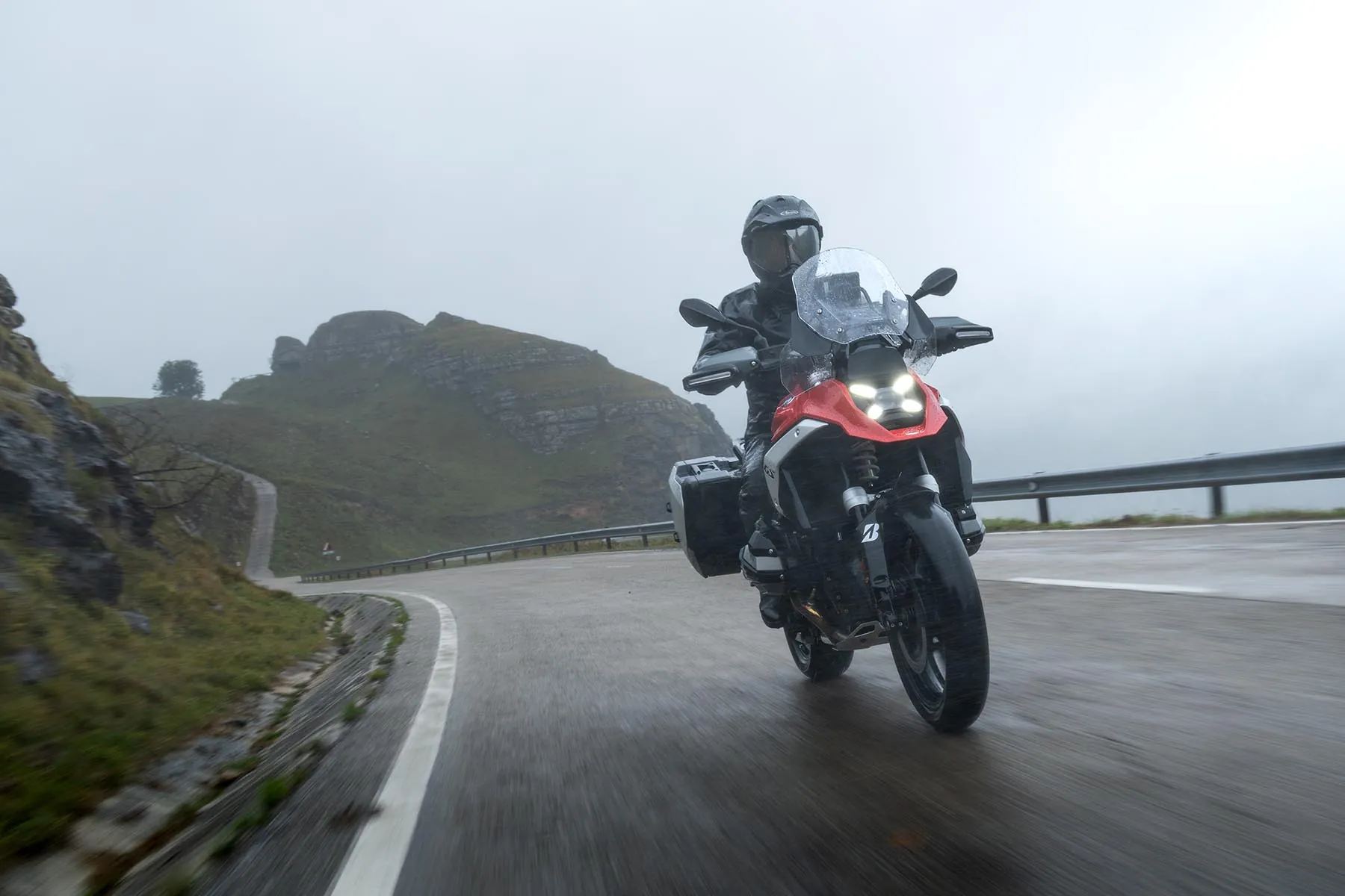 Adventure rider cornering on a wet mountain road on Bridgestone Battlax Adventure A42 tyres